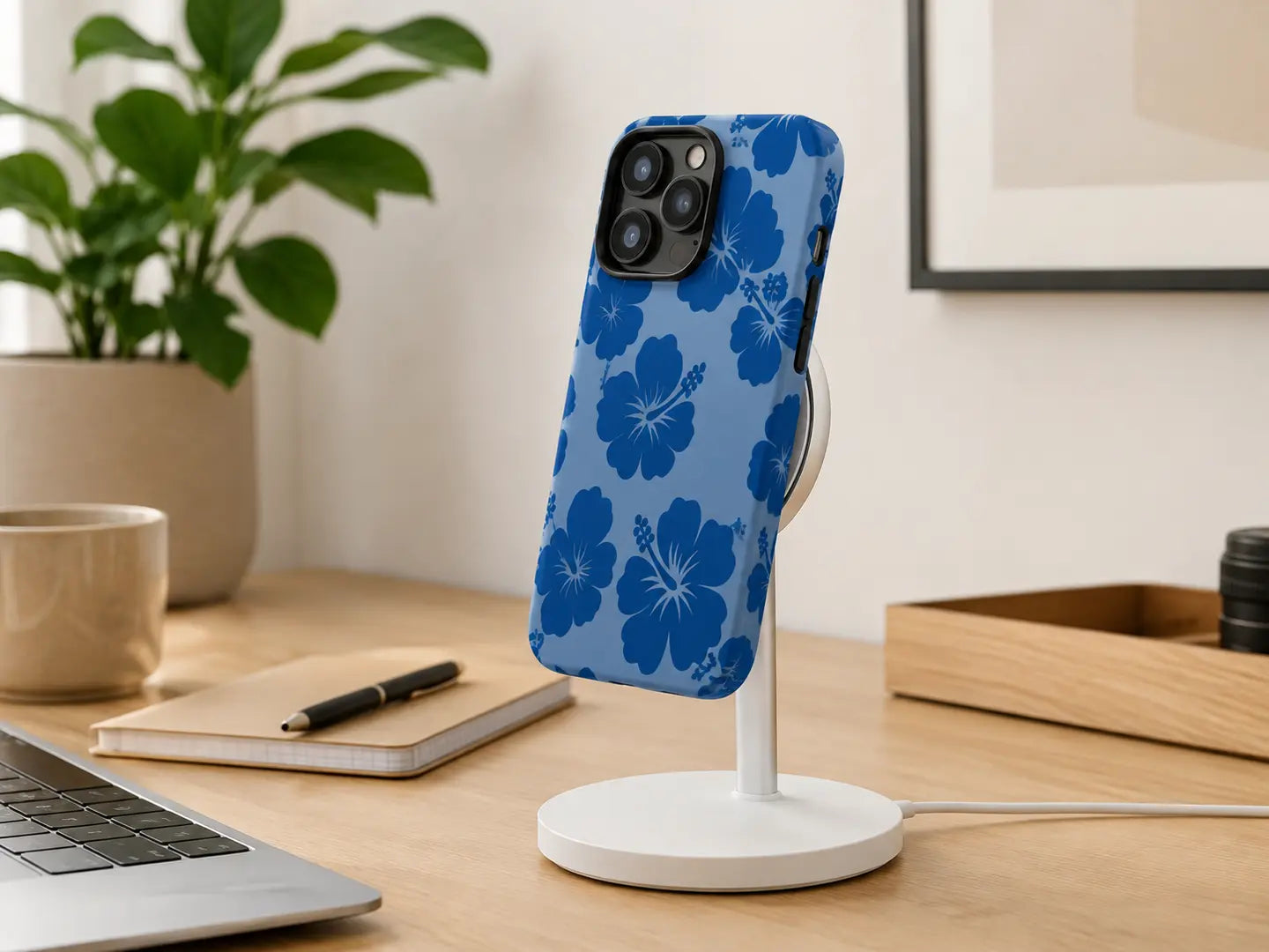 Blue hibiscus full-wrap Ehreus case attached to a magnetic charging stand